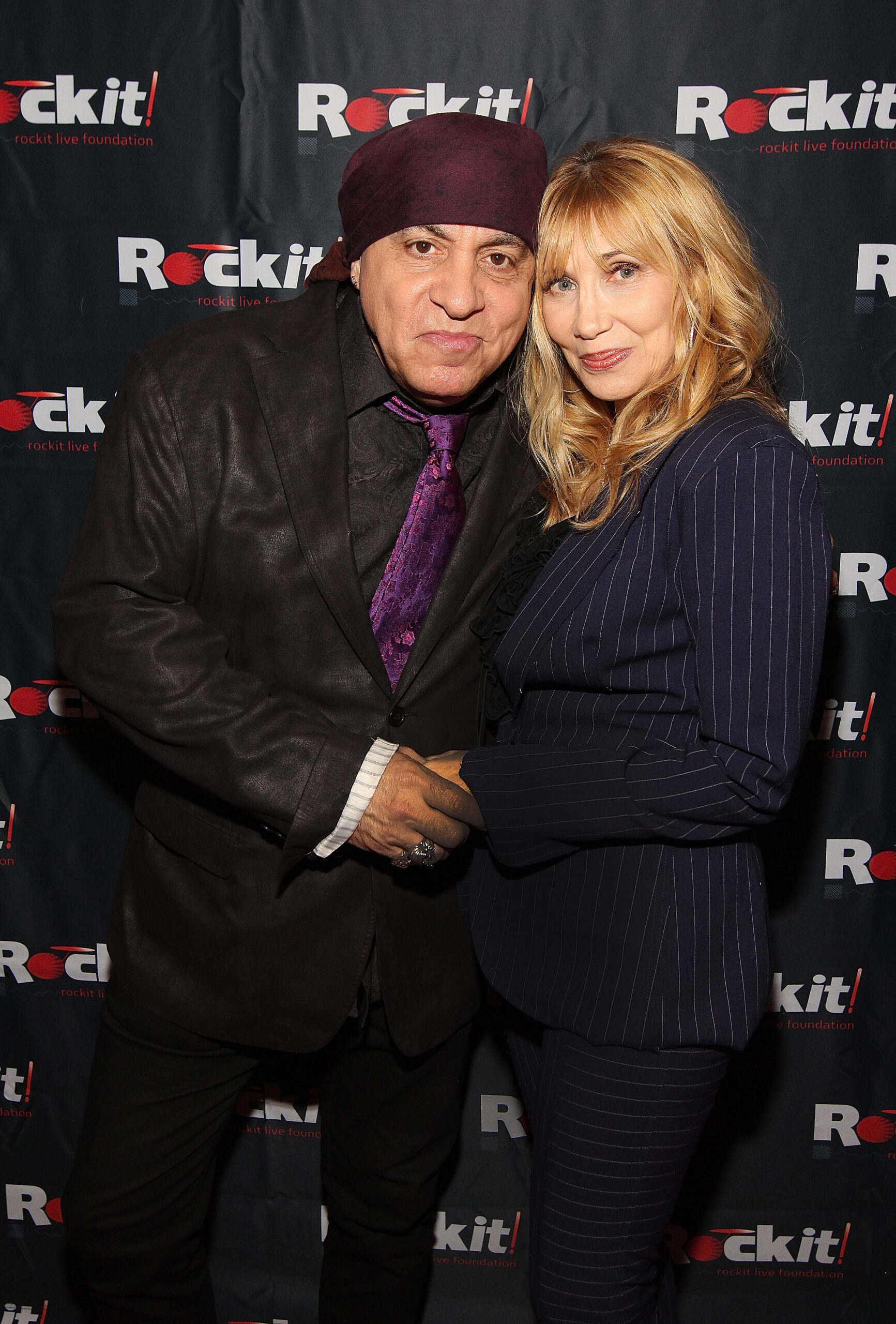 Steven & Maureen Van Zandt infront of rockit banner